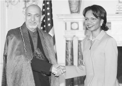 Hamid Karzai, pictured here with U.S. secretary of state Condoleezza Rice, was inaugurated as president of Afghanistan in December 2004.  Yuri Gripas/Reuters/Corbis.