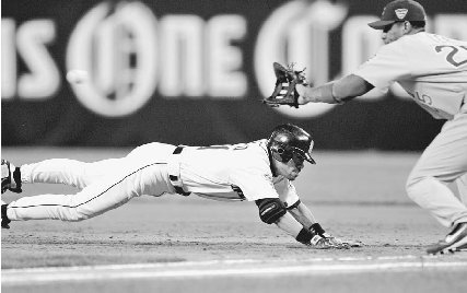 Ichiro Suzuki scrambles back to first base during the fourth inning of the 2005 Major League Baseball All-Star Game. AP/Wide World Photos.