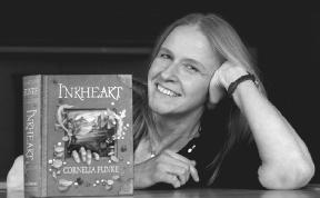 Cornelia Funke poses with her book, Inkheart.  2004 Landov LLC. All rights reserved. Repoduced by permission.