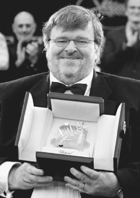 Michael Moore poses with his Palme dOr award for Farenheit 9/11 at the Cannes Film Festival. AP/Wide World Photos. Reproduced by permission.