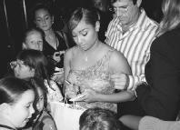 Raven signs autographs at the premiere of Cheetah Girls, in New York City. AP/Wide World Photo. Reproduced by permission.