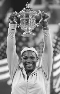 Serena Williams holds up her championship Trophy at the 2002 U.S. Open. AP/Wide World Photos. Reproduced by permission.