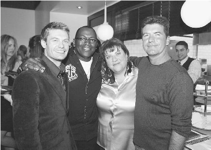 Gail Berman with American Idol stars Ryan Seacrest, Randy Jackson, and Simon Cowell. Kevin Winter/Getty Images.
