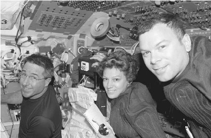The Discovery crew, including Stephen Robinson, left, Eileen Collins, center, and James Kelly, spent much of their fourteen days in space docked and working at the International Space Station. AP/ Wide World Photos.