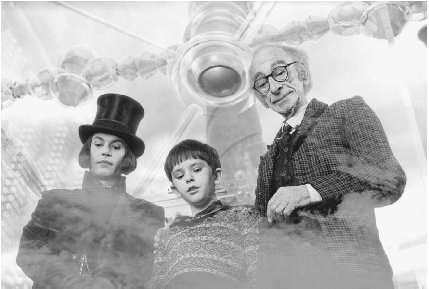 Freddie Highmore as Charlie Bucket (middle) and Johnny Depp as Willy Wonka (left) in a scene from the 2005 movie Charlie and the Chocolate Factory.  Warner Bros/Zuma/Corbis.