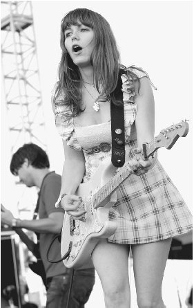 Frontperson Jenny Lewis at a 2005 Rilo Kiley performance in California. Tim Mosenfelder/Getty Images.