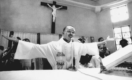 Jean-Bertrand Aristide, during services at St. Jean Bosco Church, Haiti, in 1988. AP/Wide World Photos. Reproduced by permission.
