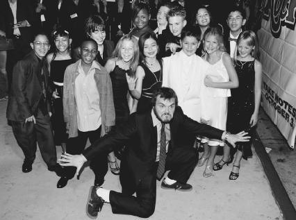 Jack Black poses with his young co-stars at the Hollywood premiere of School of Rock. AP/Wide World Photos. Reproduced by permission.