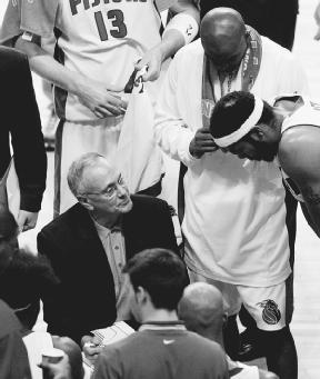Larry Brown confers with Pistons team members during a break in their 2004 game against the New Jersey Nets. AP/Wide World Photos. Reproduced by permission.