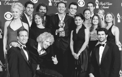 Mark Burnett (center) and the cast of Survivor: Pearl Island pose with their 2004 People's Choice Award. AP/Wide World Photos. Reproduced by permission.
