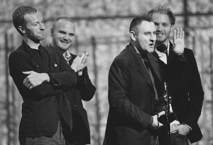 Coldplay accepts their 2004 Record of the Year Grammy. AP/Wide World Photos. Reproduced by permission.