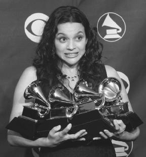 Norah Jones holds her five Grammy Awards. AP/Wide World Photos. Reproduced by permission.
