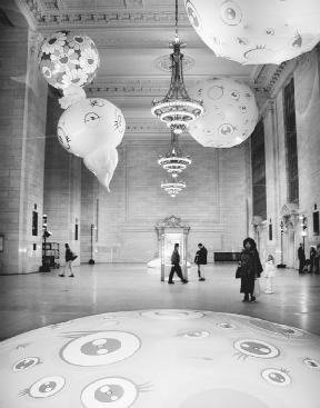 Commuters look overhead at fiberglass sculptures by Takashi Murakami on display in Grand Central Station, New York City, in 2001.  Reuters/Corbis.