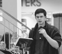 Christopher Paolini reads during a book signing at Borders in Birmingham, MI. Photograph by Denay Wilding.