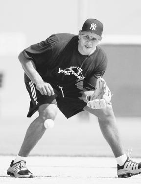 Alex Rodriguez fields a ball during practice with the New York Yankees. AP/Wide World Photos. Reproduced by permission.