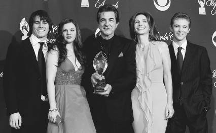 The cast of Joan of Arcadia pose backstage with their Favorite New TV Dramatic Series Peoples Choice Award. Pictured left to right: Jason Ritter, Amber Tamblyn, Joe Mantegna, Mary Steenburgen, and Michael Welch. AP/Wide World Photos. Reproduced