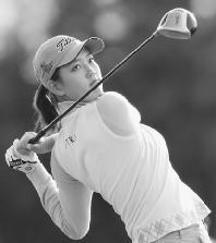 Michelle Wie watches her drive shot during the 2003 CJ Nine Bridges Classic in South Korea. AP/Wide World Photos. Reproduced by permission.