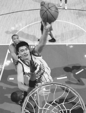 Yao Ming of the Houston Rockets shoots over Amare Stoudemire (bottom) during a 2003 game against the Phoenix Suns. AP/Wide World Photos. Reproduced by permission.